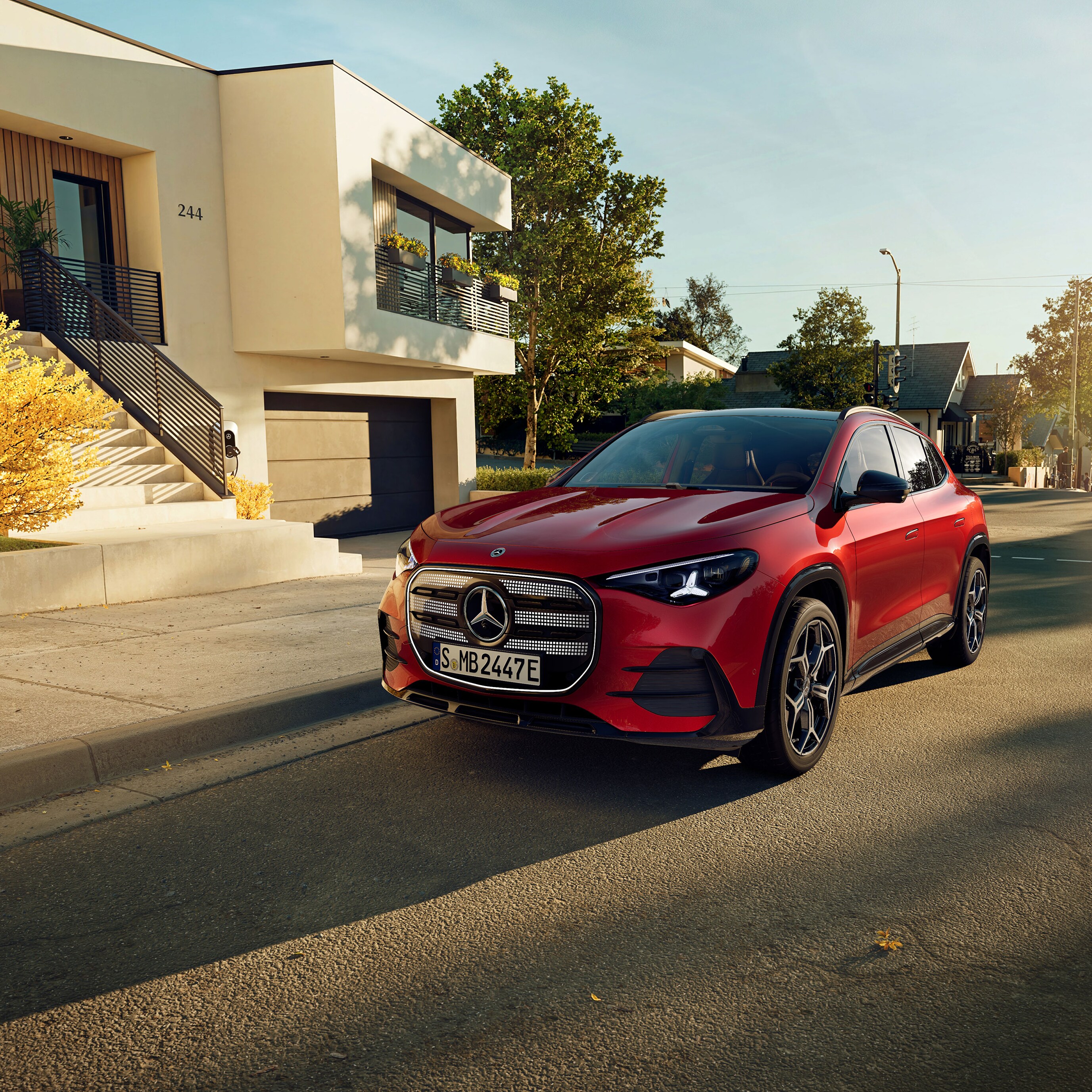 The all-new electric GLA from Mercedes-Benz parking in a parking space next to a coffee shop.