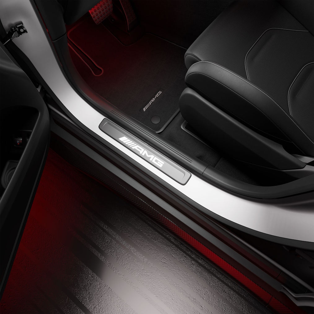 Close-up view of AMG door sills illuminated with "AMG" lettering.