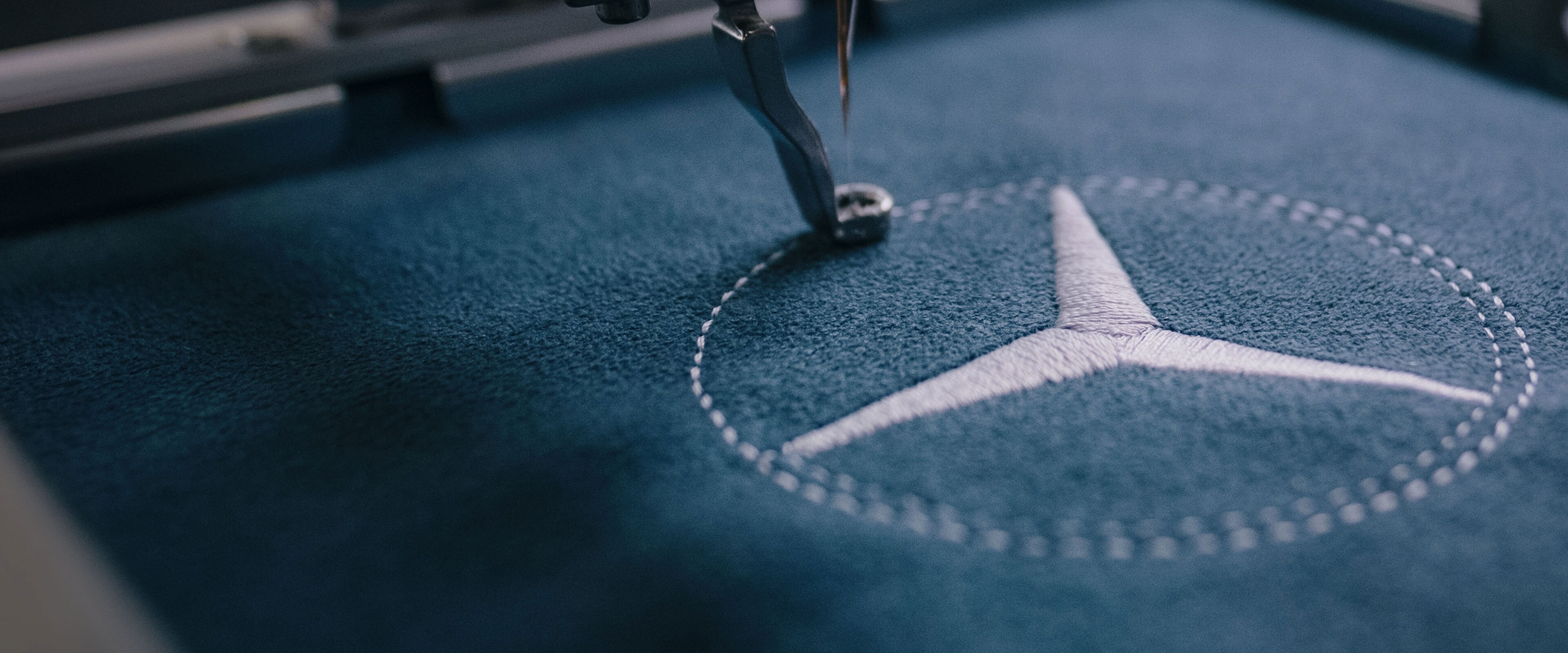 The Mercedes-Benz star is sewn onto fabric.