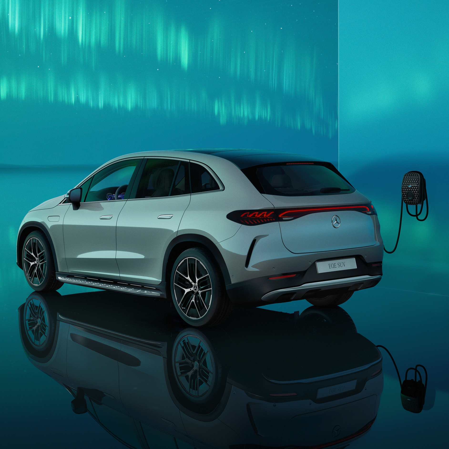 Charging | Electric vehicles | Mercedes-Benz Side rear view of the EQE SUV charging at a Mercedes Benz Wallbox.