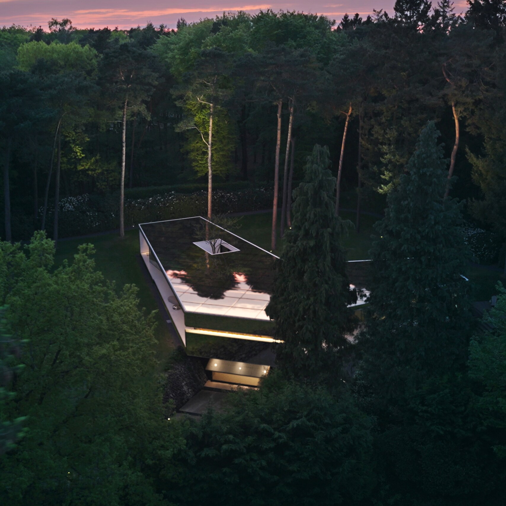 A white suburban architect house with a driveway and a garage.