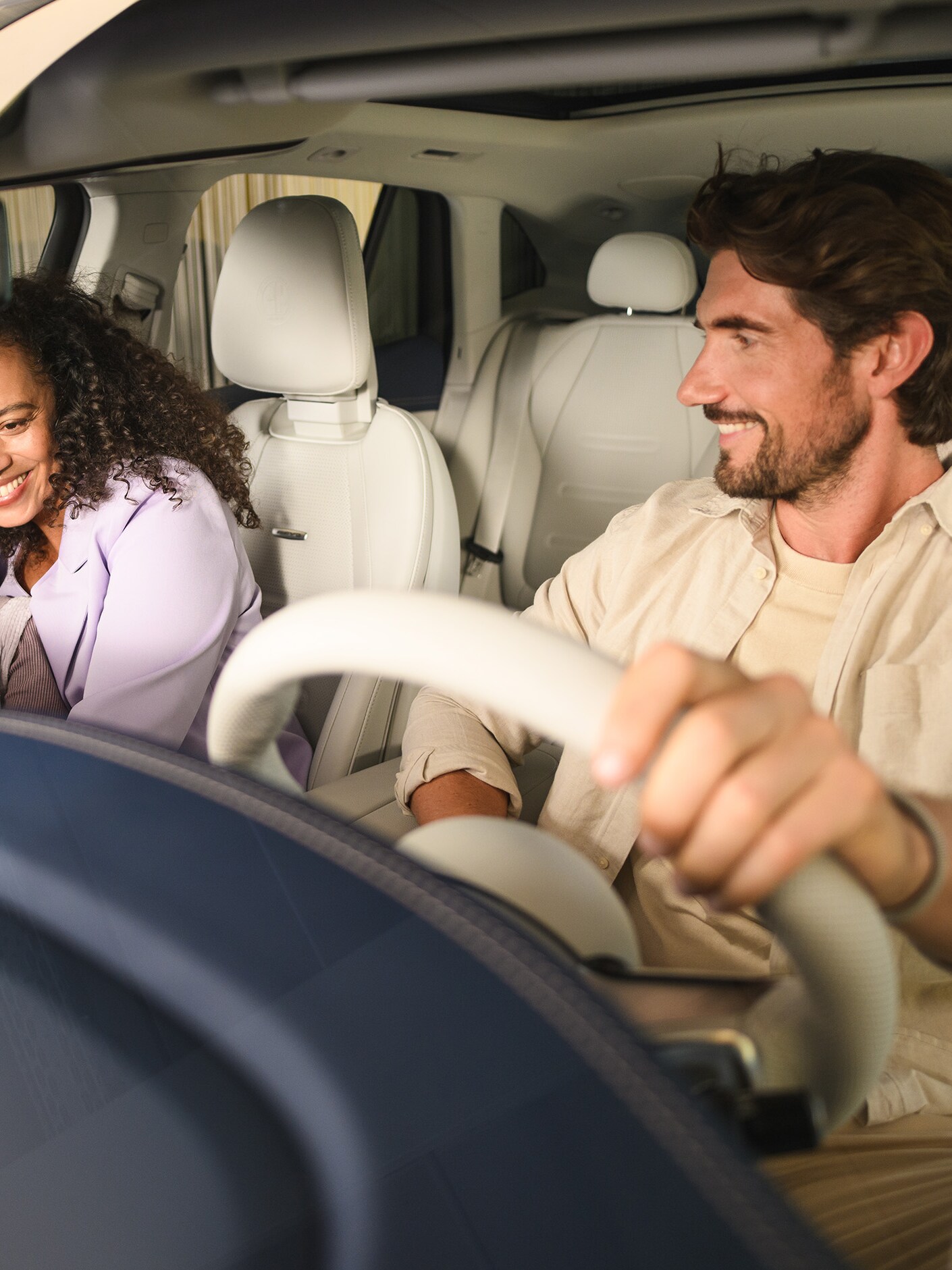 Two people and a child inside a Mercedes-Benz vehicle.