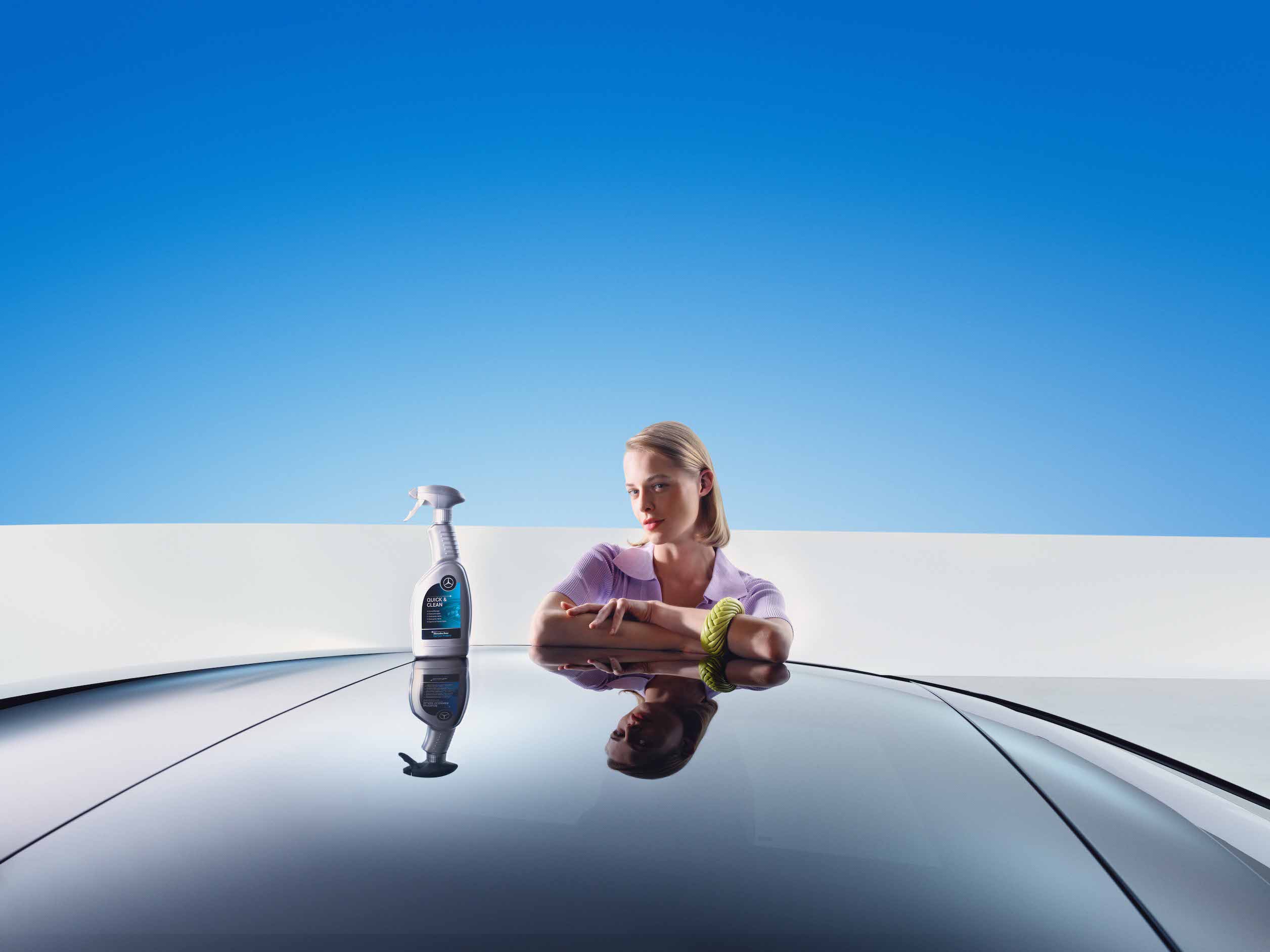 Mercedes-Benz | Genuine Car Care Products A woman leaning on her freshly cleaned Mercedes-Benz.