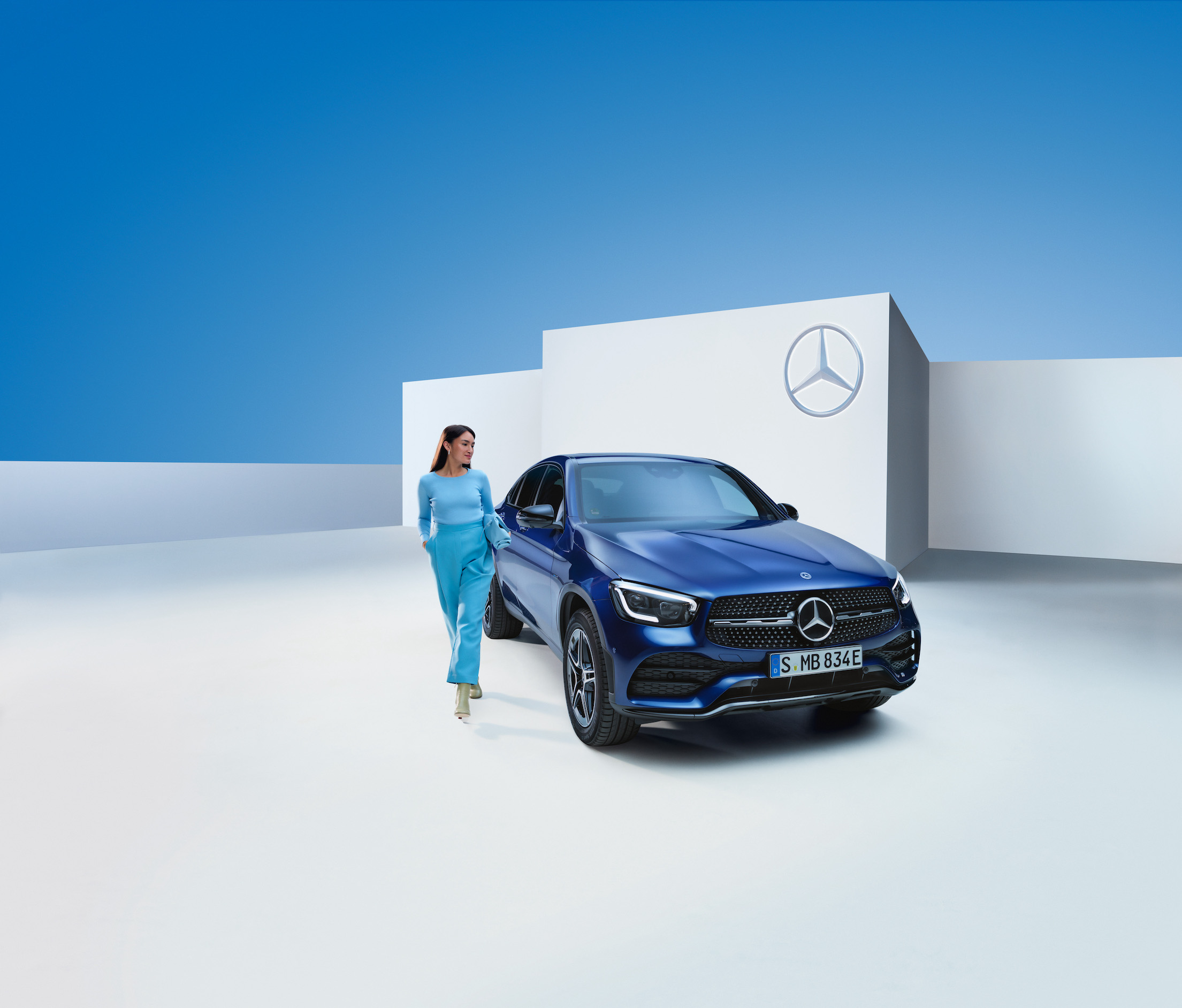 Mercedes-Benz | Genuine Car Care Products A woman standing next to her Mercedes-Benz.