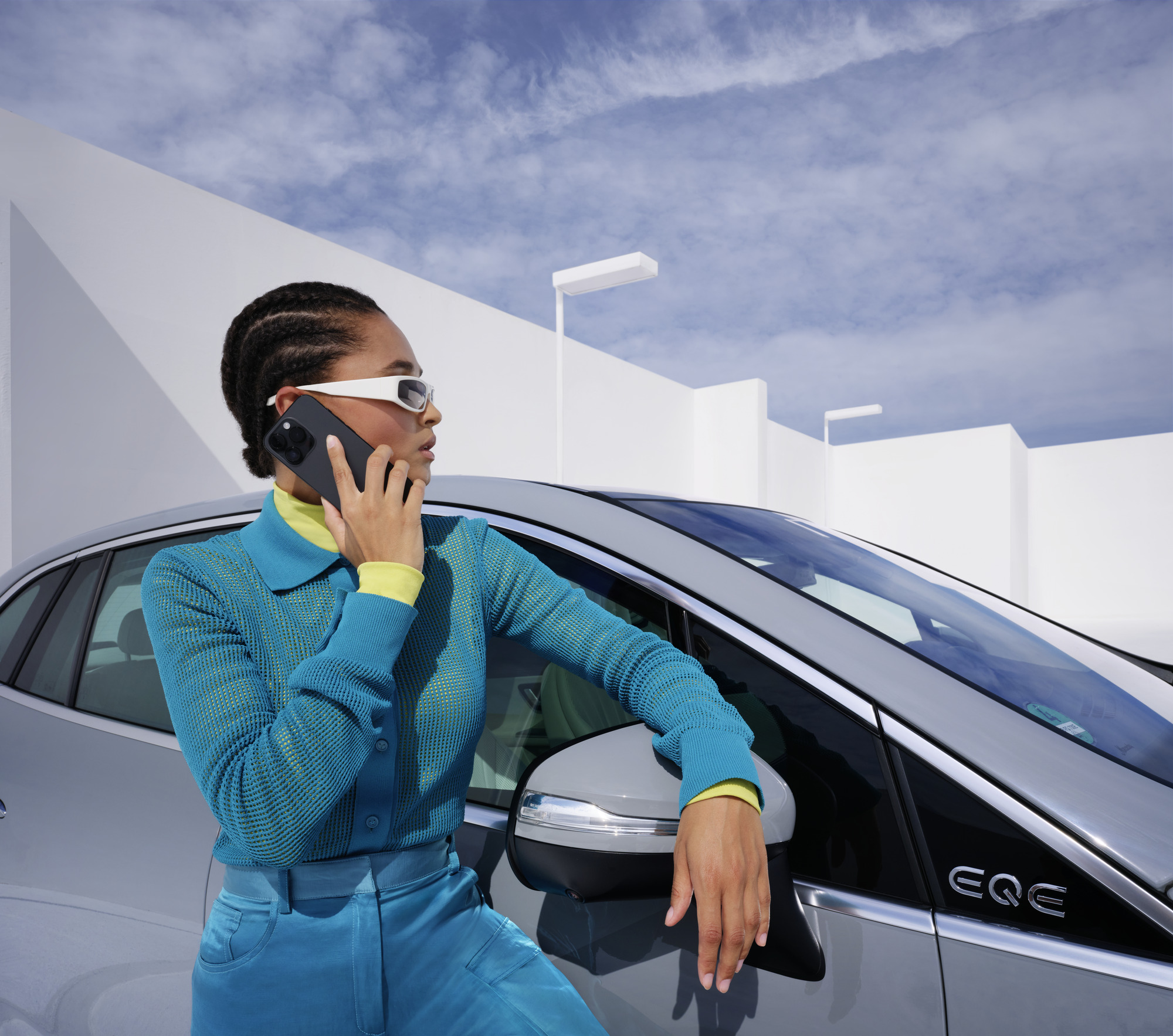 Damage and Breakdown | Mercedes-Benz Woman leaning on her Mercedes-Benz on the phone.