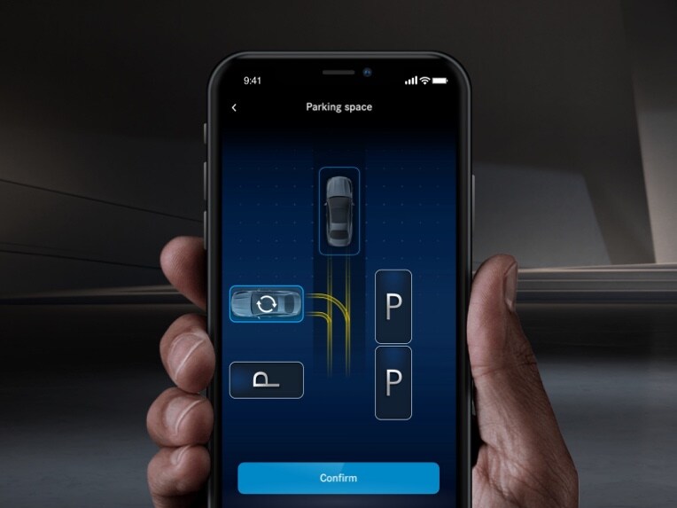 A smartphone being used to park a Mercedes-Benz using the Mercedes me Remote Parking Assist.