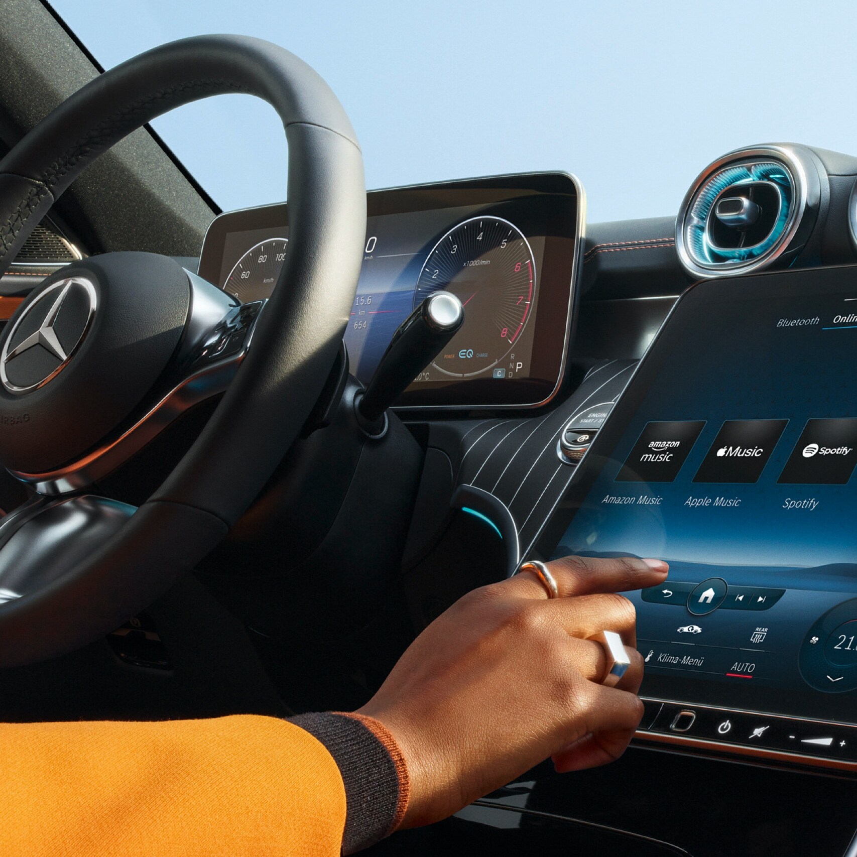Person selecting the desired audio streaming service from Amazon Music, Apple Music, Spotify and TIDAL on the screen of the MBUX multimedia system in a Mercedes-Benz.