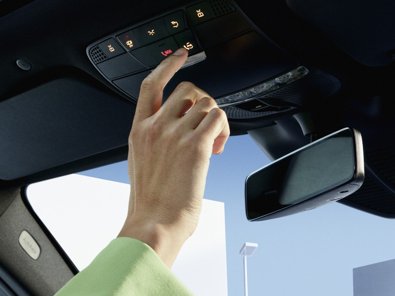 Person pressing the Mercedes me button in the control panel