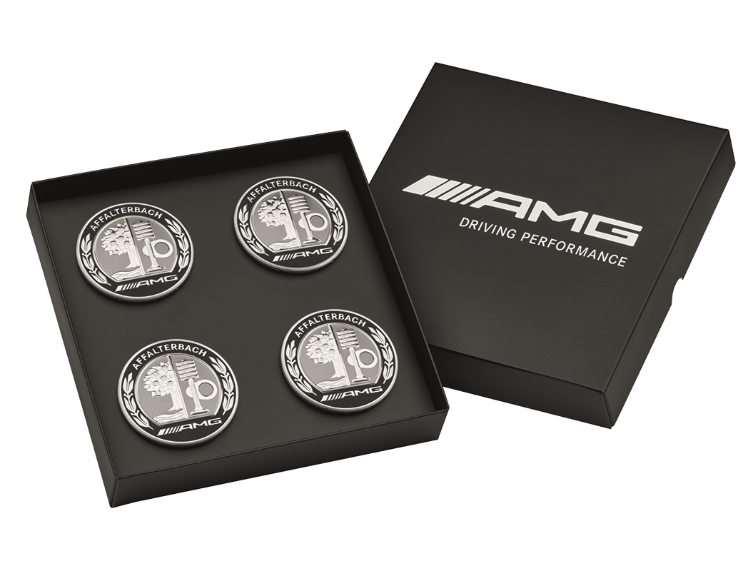 Four silver and black AMG hub caps with emblem pictured in a black box.