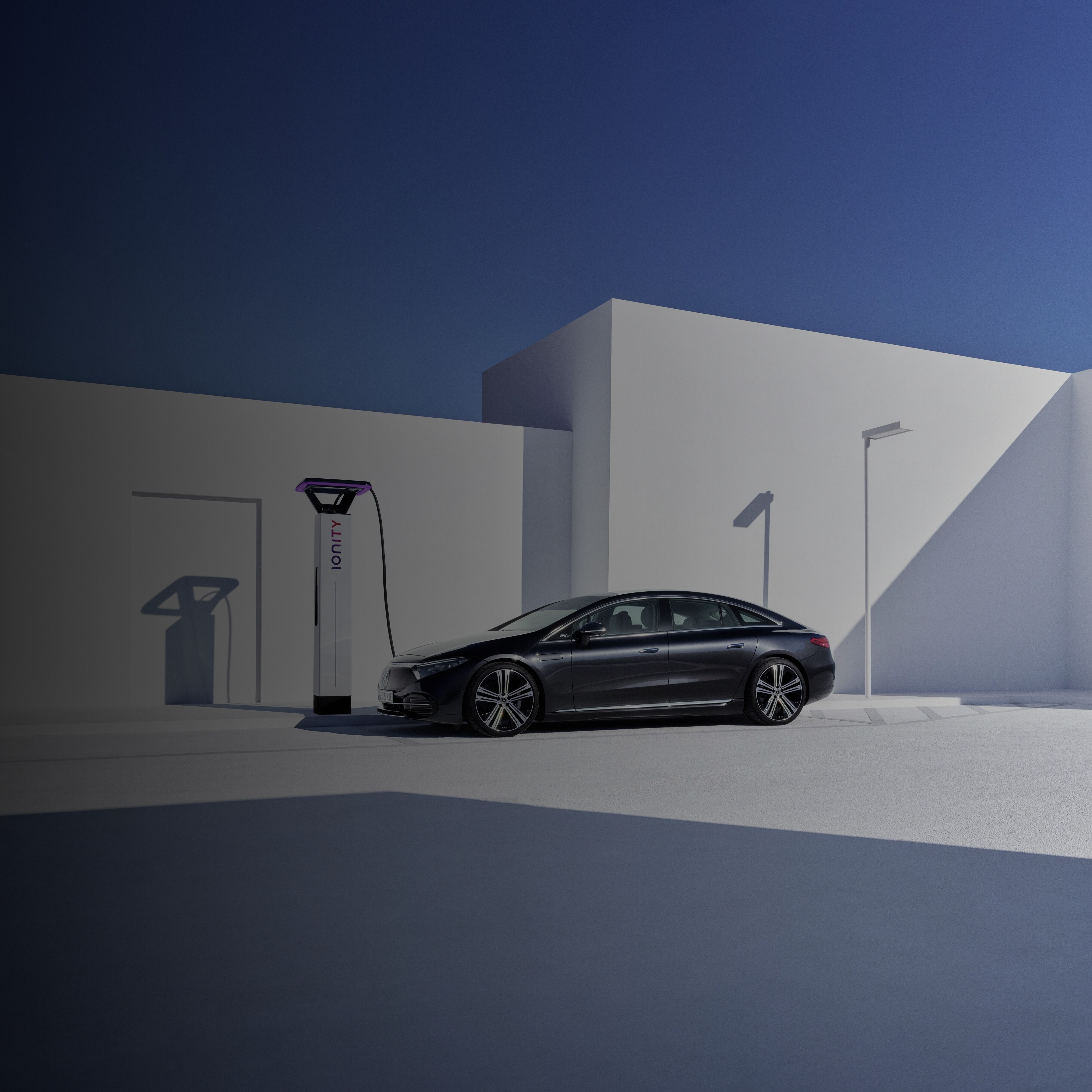 A Mercedes-Benz EQS charges at an IONITY High Power Charging network charging station