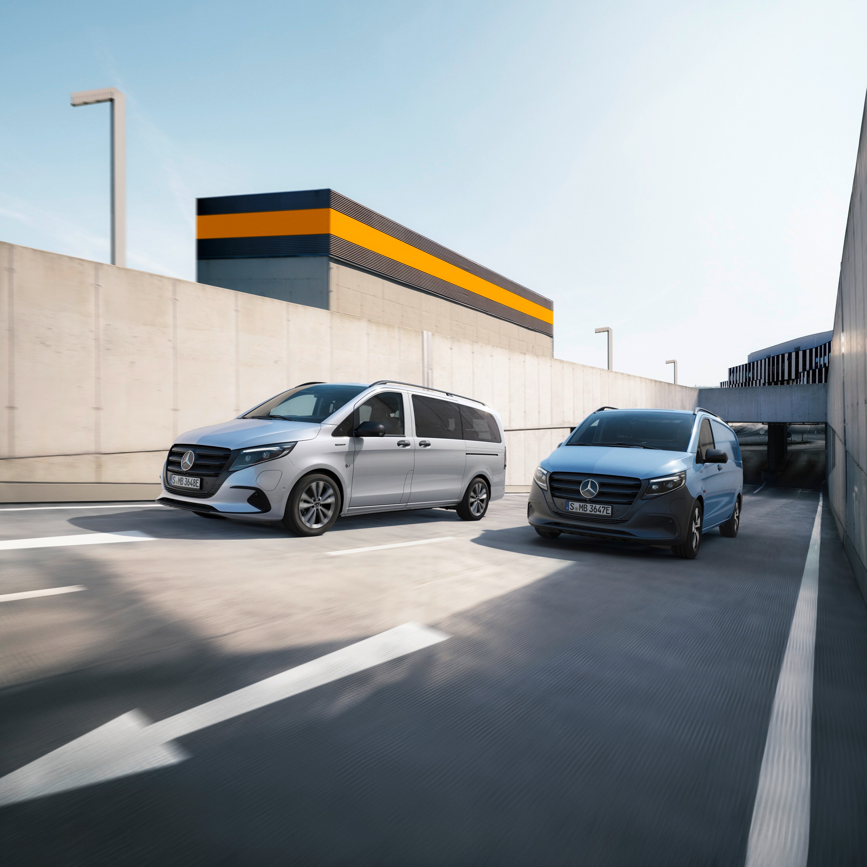 Mercedes-Benz eVito Tourer and eVito Panel Van driving on a road. 
