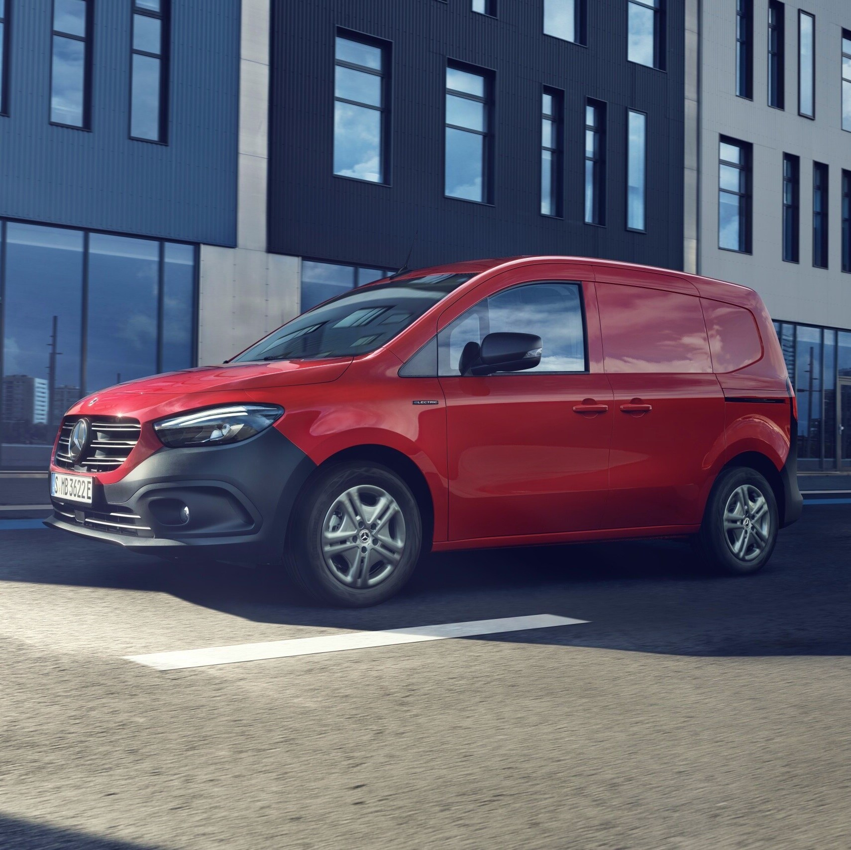 The eCitan panel van, a small electric van from Mercedes-Benz, driving along a downtown street.